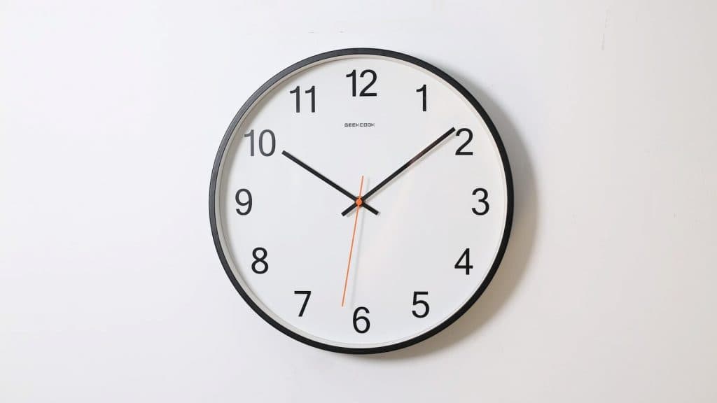 round analog wall clock pointing at 10:09
