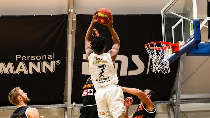 people playing basketball inside court