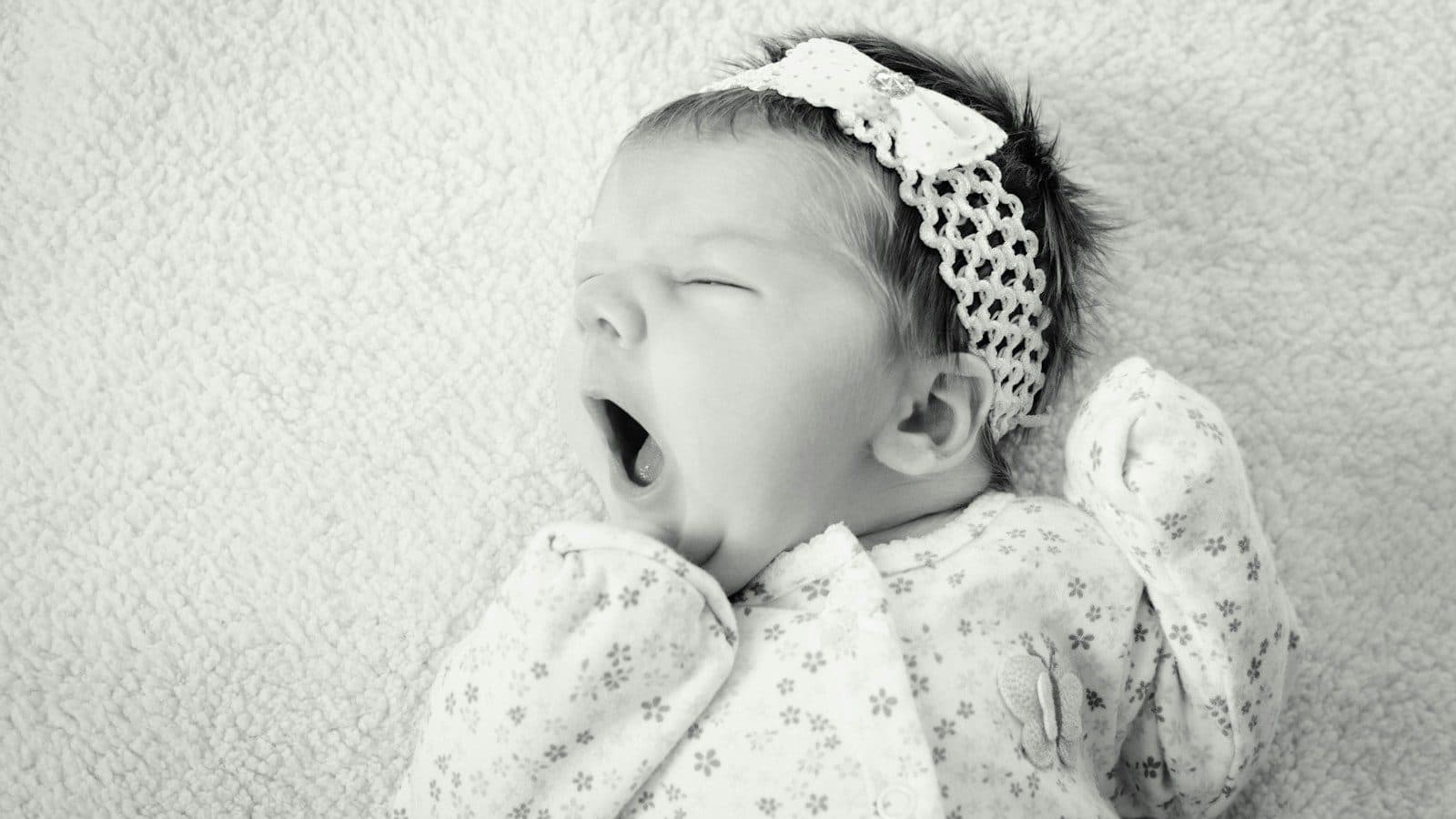 baby wearing sleeper suit