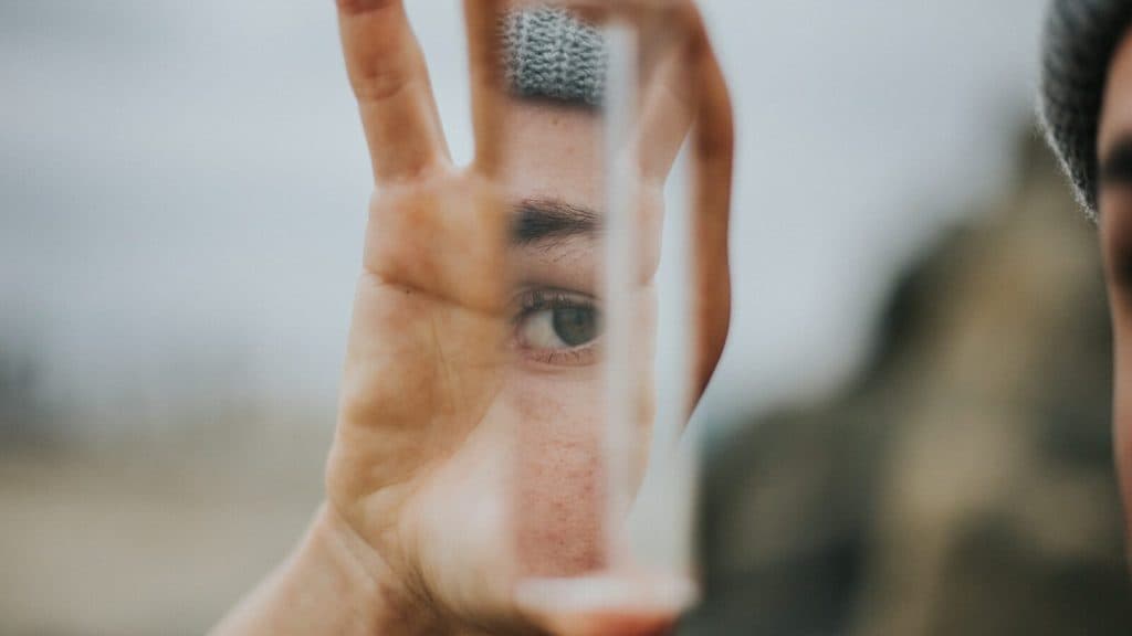 shallow focus of person holding mirror
